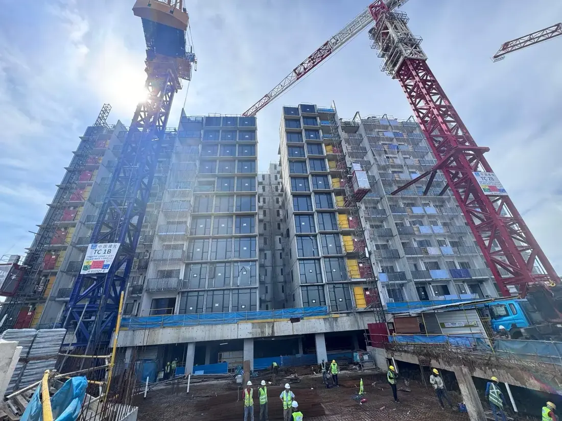 High-rise residential development being assembled with PPVC modules and tower cranes