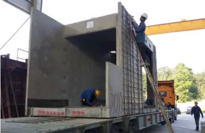 Concrete PPVC module secured on a trailer for transport from factory to construction site
