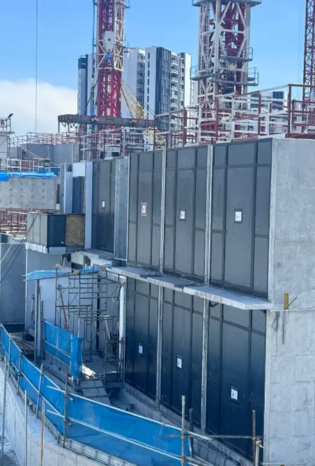 Multiple completed PPVC modules installed across a high-rise residential building