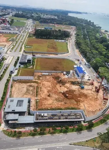 Aerial view of the Bayshore development site beside the coastline and transport infrastructure