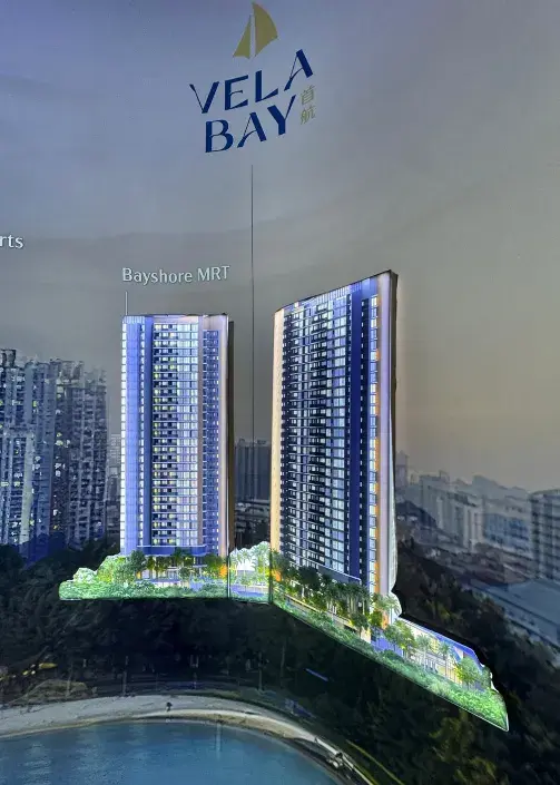 Vela Bay launch display showing two residential towers beside Bayshore MRT and the coastline