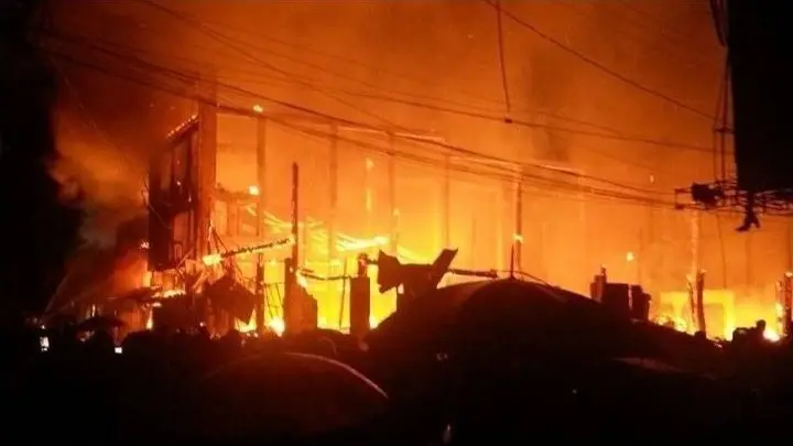 Wooden shophouses burning at night