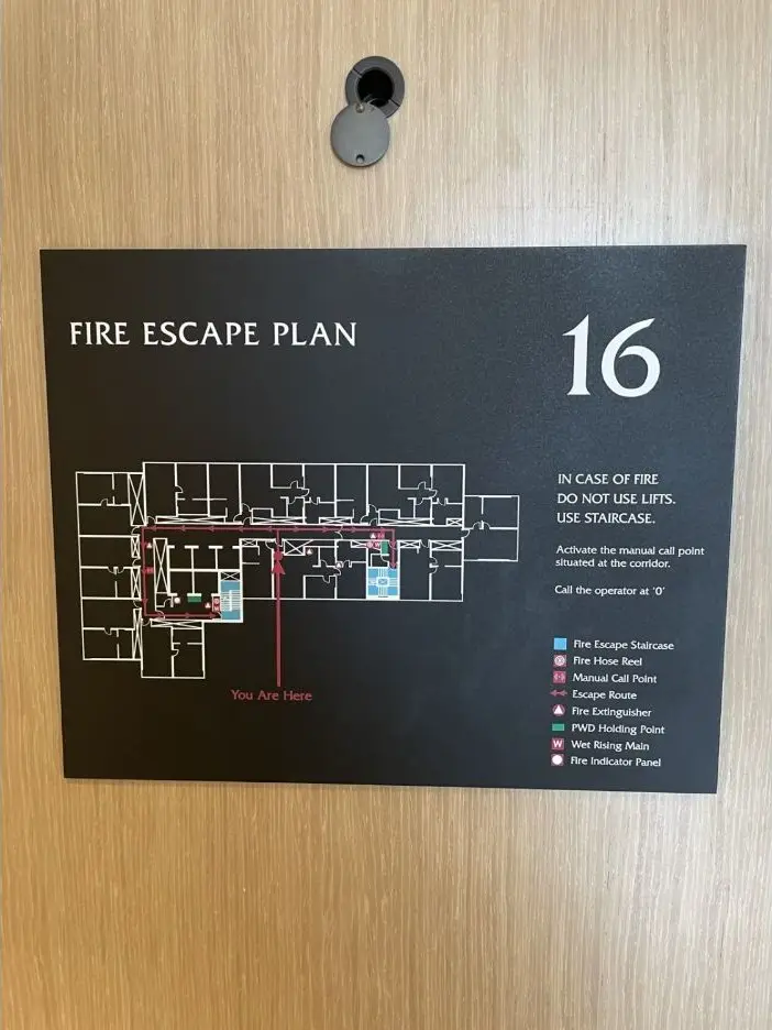 Hotel fire escape plan mounted on a guestroom door