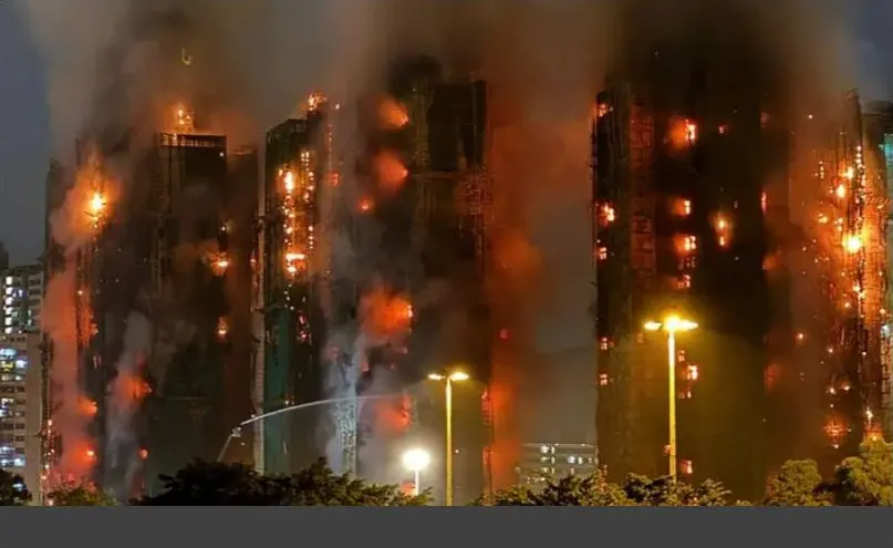 High-rise residential towers at Wang Fuk Court burning at night