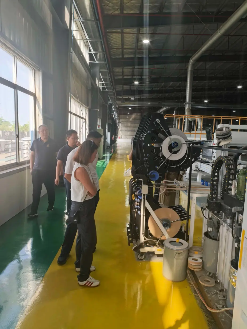 Project team reviewing a production line during a Guangdong factory visit