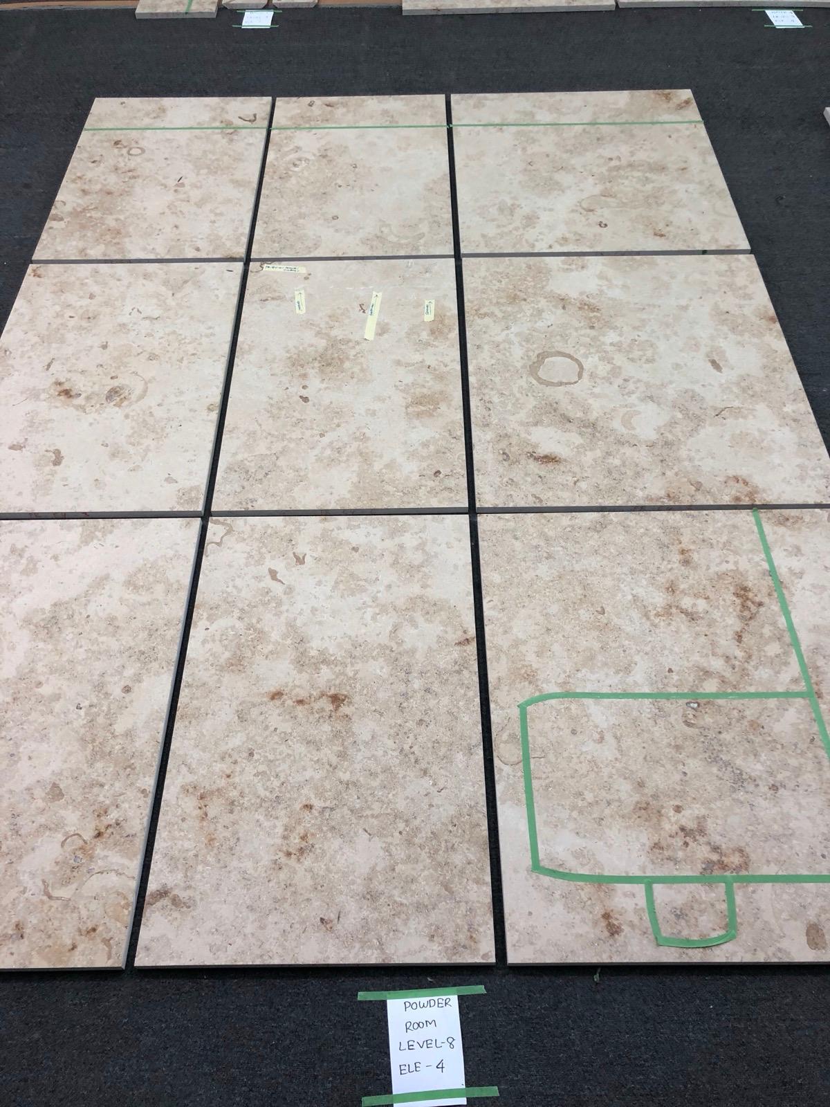 Jura Beige limestone pieces arranged during dry-lay with fossil markings visible