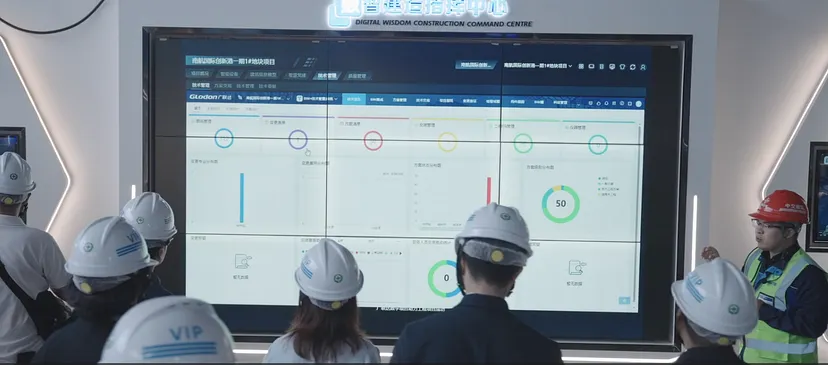 Project team reviewing a live dashboard for crane, labour and material coordination at a Nanjing construction site